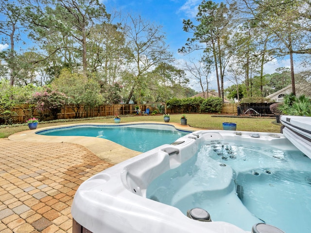 view of pool with a patio, a yard, a fenced backyard, and a hot tub