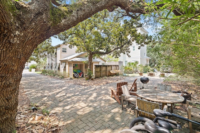 view of patio / terrace featuring a fire pit and fence