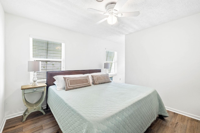 bedroom with baseboards, a textured ceiling, wood finished floors, and a ceiling fan