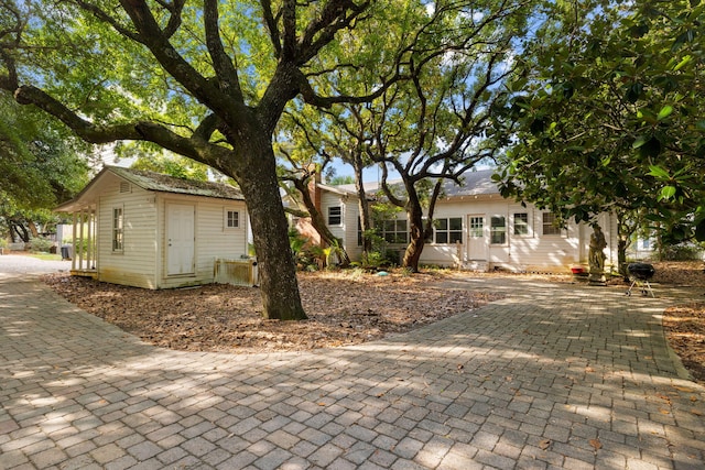 view of front of home with decorative driveway