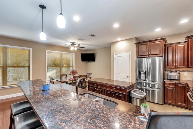 kitchen with visible vents, stainless steel fridge with ice dispenser, decorative light fixtures, recessed lighting, and a sink