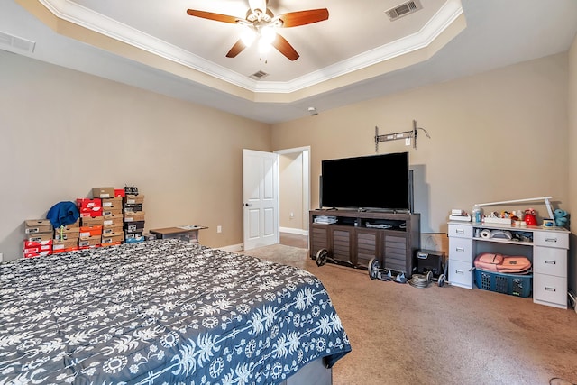 bedroom with visible vents, crown molding, and a tray ceiling