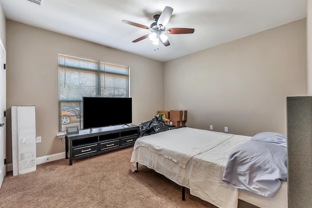 carpeted bedroom with a ceiling fan and baseboards