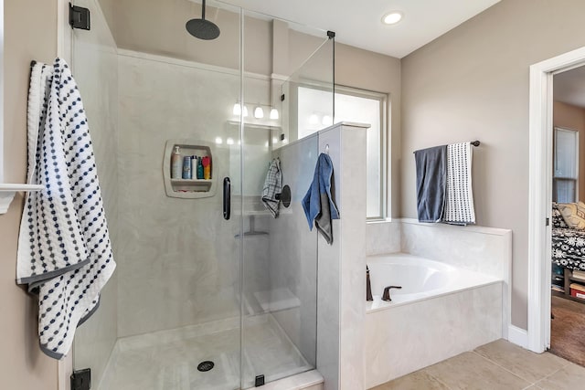 full bathroom featuring tile patterned floors, a garden tub, and a shower stall