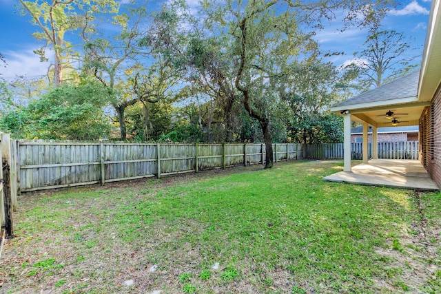 view of yard with a patio area, a fenced backyard, and ceiling fan