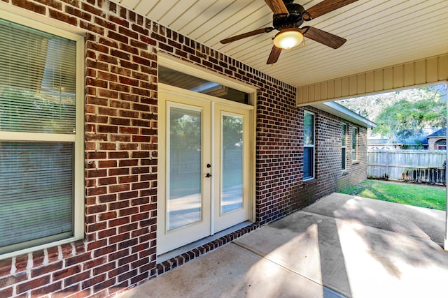 view of patio / terrace with a ceiling fan, fence, and french doors