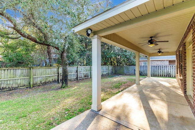 view of yard featuring a fenced backyard, a patio, and a ceiling fan