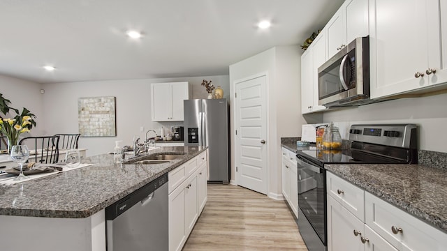 217 Eunola Ln, Freeport, FL 32439 - kitchen featuring light wood-type flooring, stainless steel appliances, white cabinets, and a sink