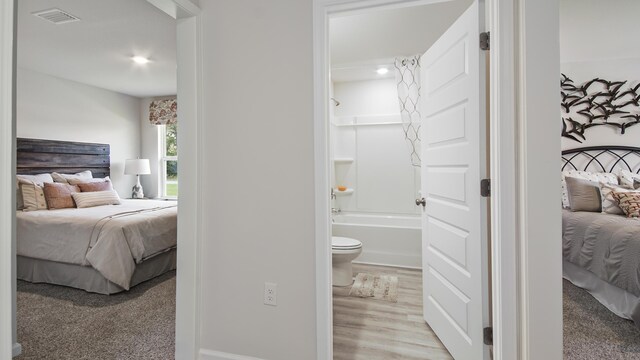 217 Eunola Ln, Freeport, FL 32439 - bedroom with visible vents, baseboards, wood finished floors, and ensuite bathroom