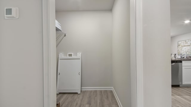 217 Eunola Ln, Freeport, FL 32439 - washroom featuring baseboards, light wood finished floors, and a sink