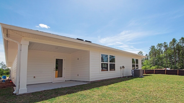 217 Eunola Ln, Freeport, FL 32439 - rear view of house with a lawn, fence, central AC, and a patio