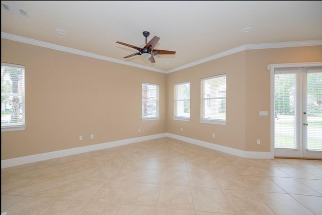 spare room with light tile patterned floors, baseboards, and ornamental molding