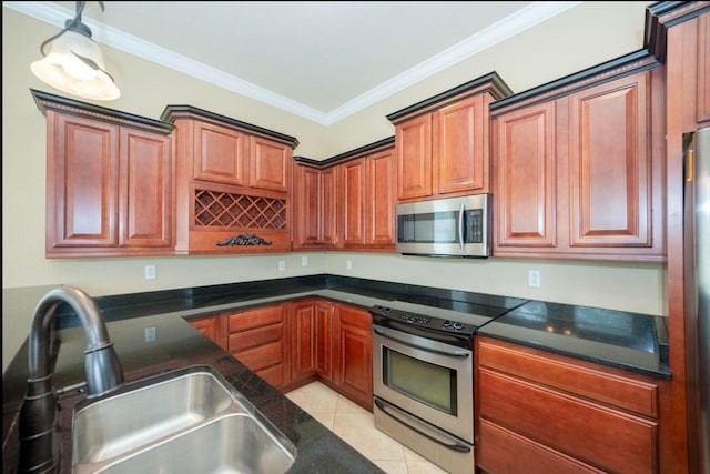 kitchen with a sink, stainless steel appliances, dark stone counters, crown molding, and light tile patterned floors