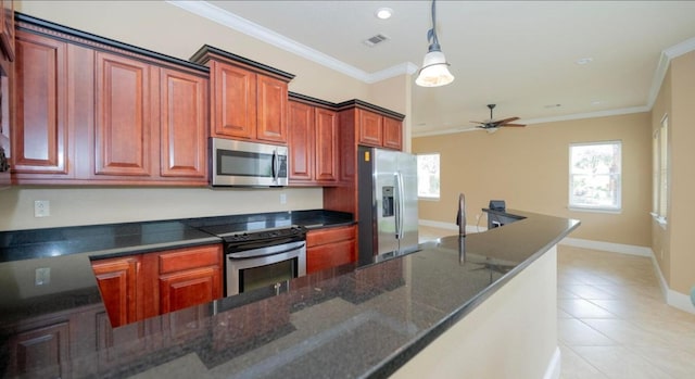 kitchen featuring ornamental molding, dark stone countertops, stainless steel appliances, light tile patterned floors, and hanging light fixtures