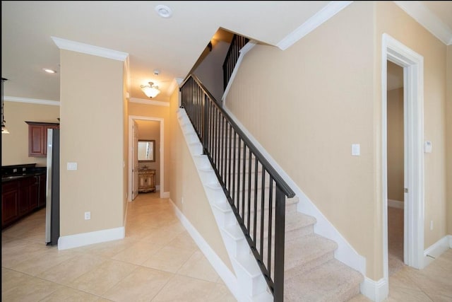 stairs featuring tile patterned floors, baseboards, and ornamental molding