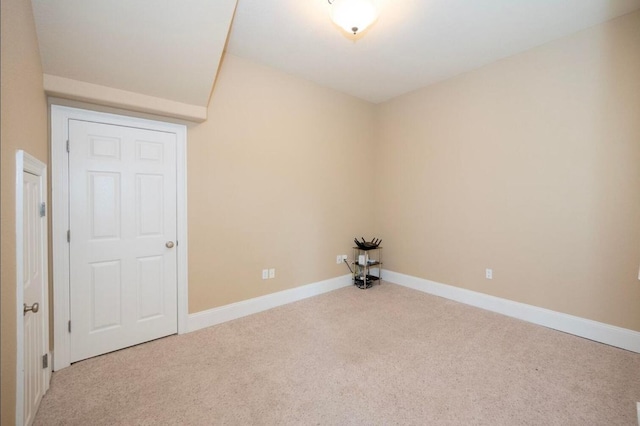 empty room featuring baseboards and carpet floors