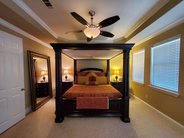 bedroom with visible vents, light colored carpet, crown molding, and baseboards