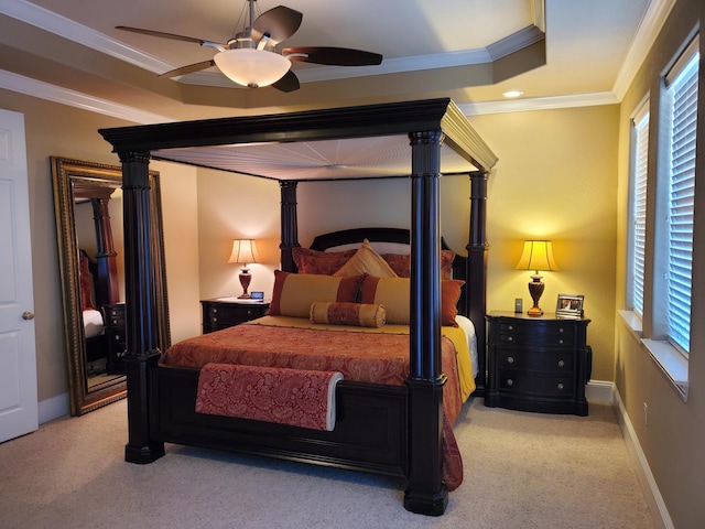 bedroom with carpet flooring, multiple windows, baseboards, and crown molding