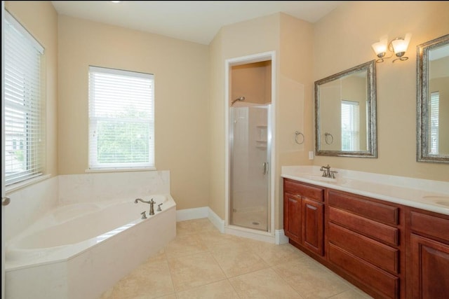 full bathroom with baseboards, double vanity, tile patterned flooring, a shower stall, and a garden tub