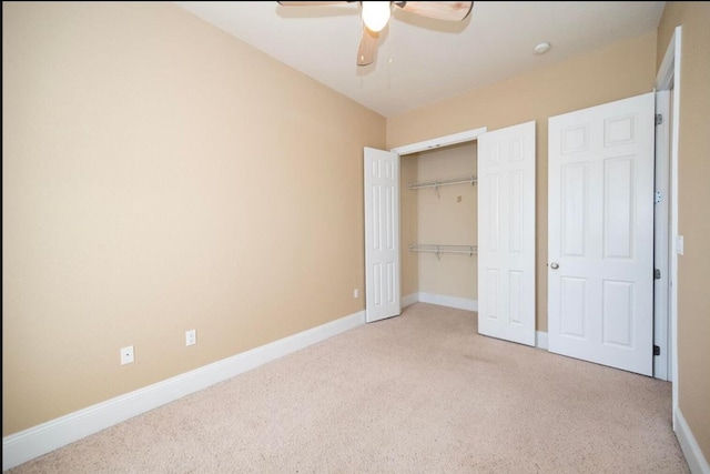 unfurnished bedroom featuring a closet, baseboards, a ceiling fan, and carpet flooring