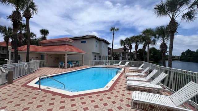 pool with fence and a patio area