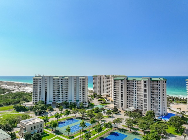 birds eye view of property with a water view and a beach view