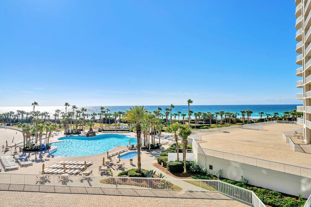 pool featuring a patio and a water view