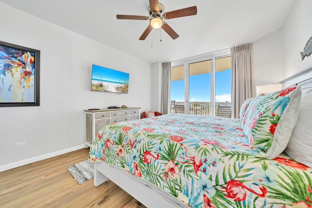 bedroom with access to outside, wood finished floors, baseboards, and ceiling fan