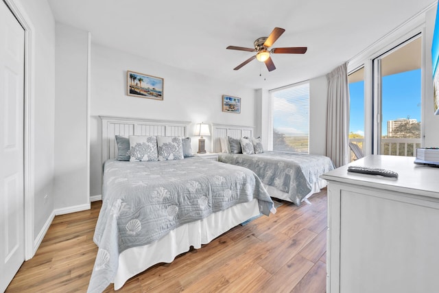 bedroom featuring light wood-style floors, baseboards, and ceiling fan