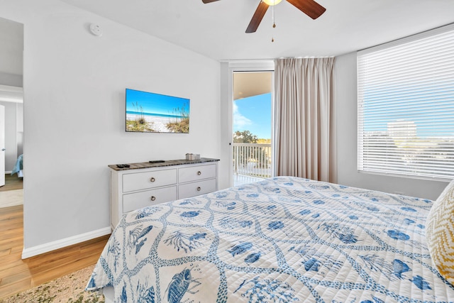 bedroom featuring wood finished floors, a ceiling fan, baseboards, and access to outside