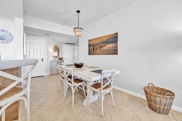 dining space featuring an inviting chandelier, light tile patterned flooring, and baseboards