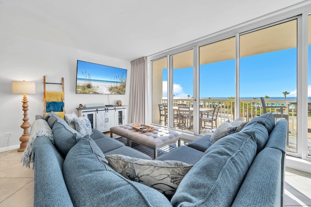 living room featuring tile patterned floors, floor to ceiling windows, and baseboards