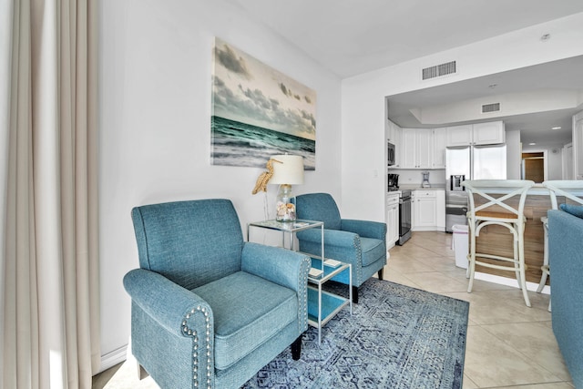 sitting room with light tile patterned floors and visible vents