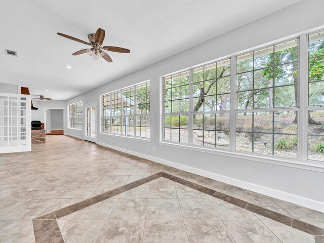 unfurnished living room with visible vents, ceiling fan, baseboards, recessed lighting, and a textured ceiling