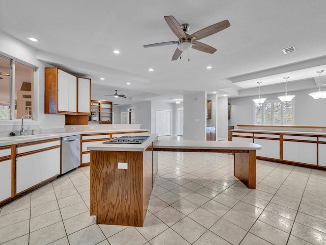 kitchen featuring visible vents, a sink, light tile patterned flooring, stovetop with downdraft, and dishwasher