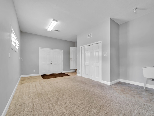 interior space featuring visible vents, baseboards, and carpet floors