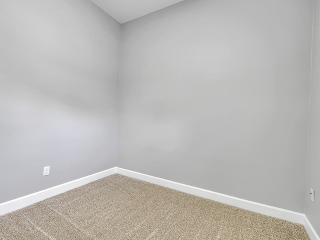 spare room with carpet and baseboards