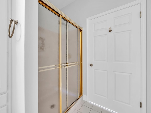 bathroom featuring tile patterned floors and an enclosed shower