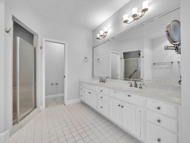 bathroom featuring double vanity, tile patterned flooring, a stall shower, and a sink