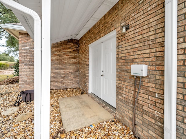 doorway to property with brick siding