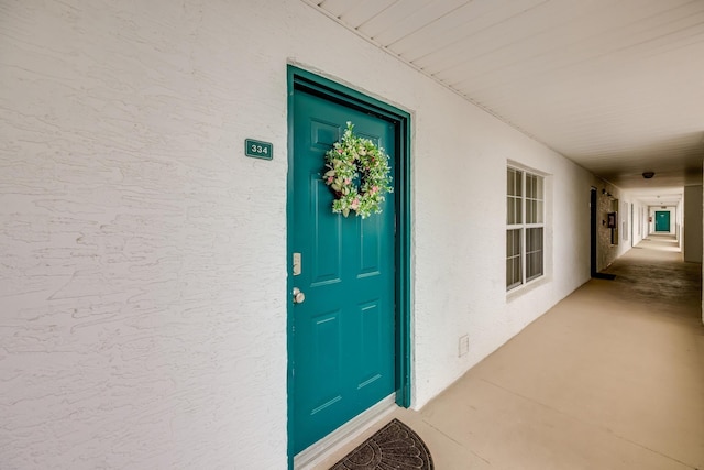 doorway to property with stucco siding