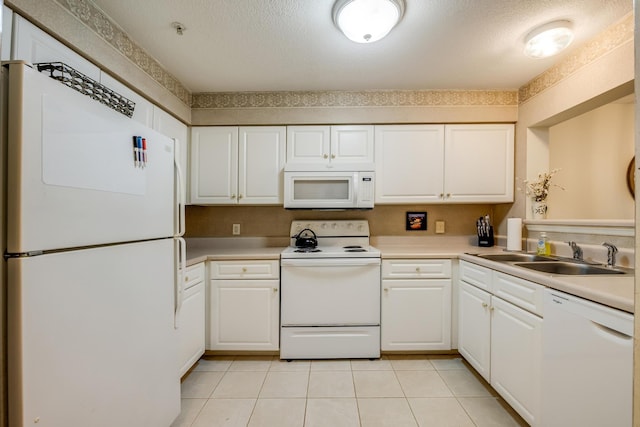 kitchen with white cabinetry, white appliances, a textured ceiling, and a sink