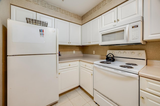 kitchen featuring light tile patterned floors, white appliances, white cabinetry, and light countertops