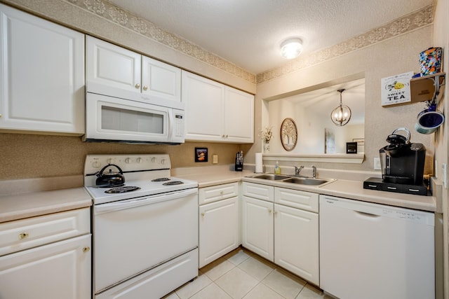 kitchen featuring white appliances, light tile patterned floors, a sink, light countertops, and white cabinetry