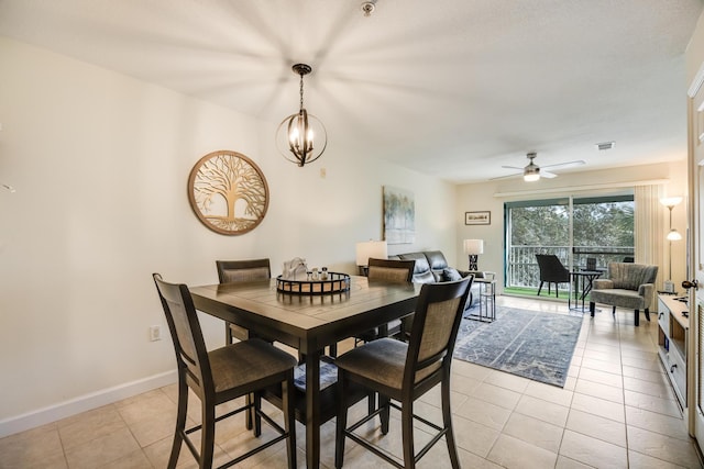 dining area with light tile patterned floors, visible vents, baseboards, and ceiling fan with notable chandelier