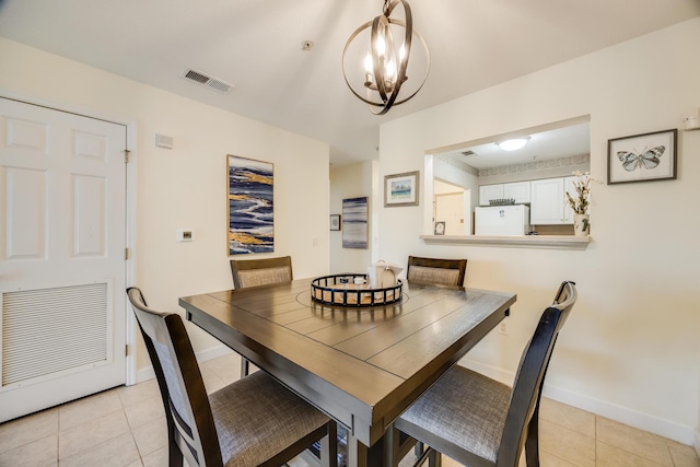 dining room with light tile patterned floors, baseboards, and visible vents