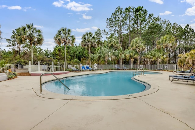 pool featuring a patio and fence