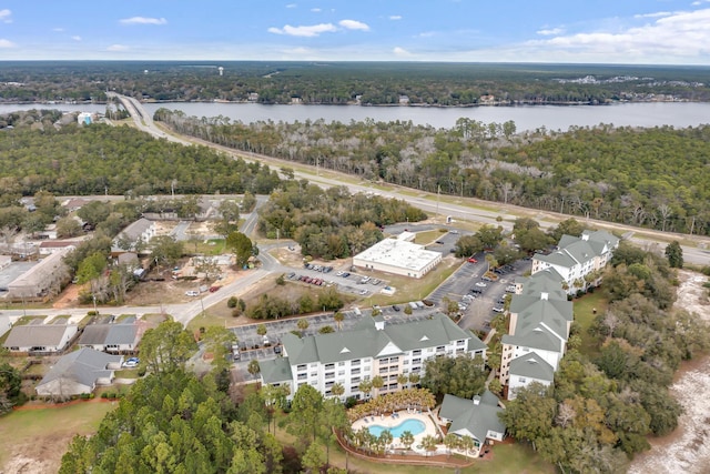 birds eye view of property with a forest view and a water view