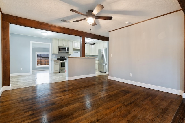 kitchen featuring visible vents, appliances with stainless steel finishes, open floor plan, and hardwood / wood-style flooring