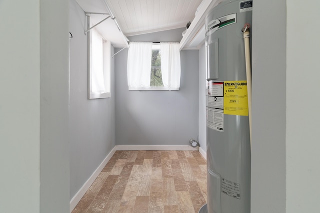 laundry room featuring water heater, laundry area, and baseboards